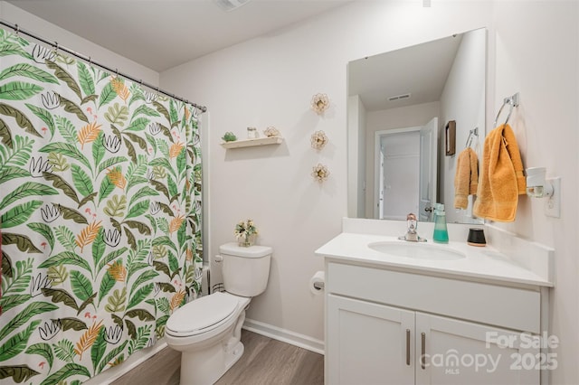 711 Saddlebred Ln, Locust, NC 28097 - full bathroom with wood finished floors, vanity, toilet, baseboards, and a shower with curtain