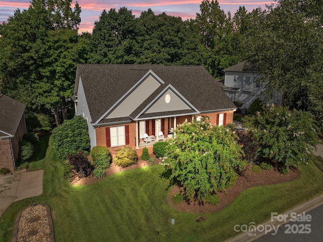 1525 Valhalla Dr, Denver, NC 28037 - view of front of home featuring brick siding, a front lawn, covered porch, and roof with shingles