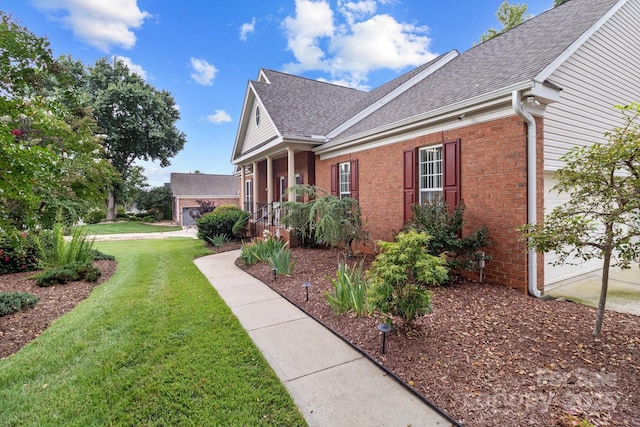 1525 Valhalla Dr, Denver, NC 28037 - view of side of property with brick siding, a yard, roof with shingles, and covered porch