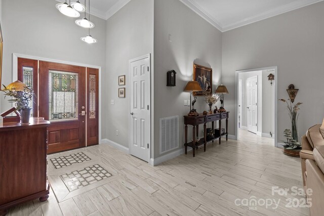 1525 Valhalla Dr, Denver, NC 28037 - foyer entrance with a high ceiling, baseboards, ornamental molding, and wood finished floors