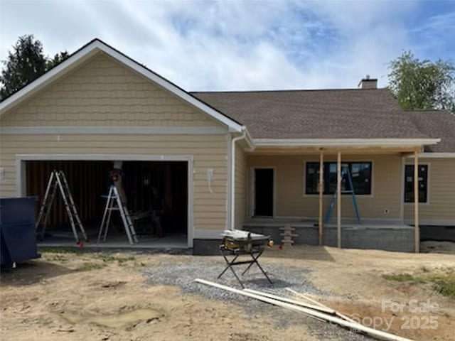 26 Olde Oak Ct, Hendersonville, NC 28792 - view of front of home featuring an attached garage, a chimney, and dirt driveway