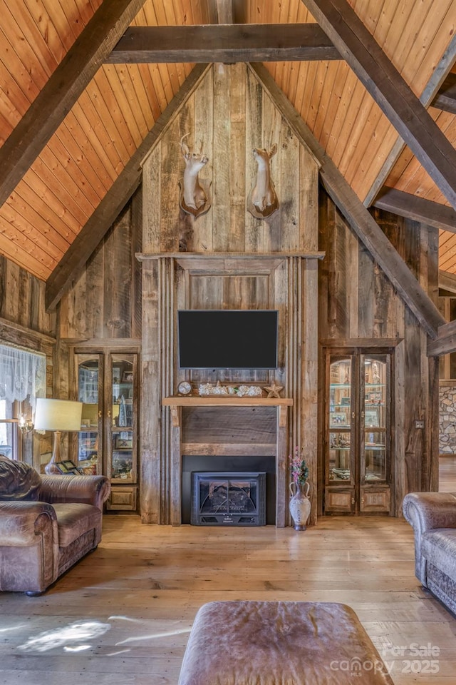 164 Avery County High School Rd, Newland, NC 28657 - living room with high vaulted ceiling, wood ceiling with exposed beams, wood-type flooring, wooden walls, and a fireplace