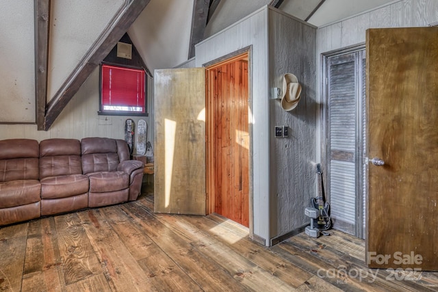 164 Avery County High School Rd, Newland, NC 28657 - living room with vaulted ceiling, hardwood / wood-style floors, and wooden walls