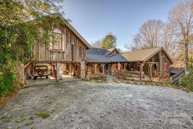 164 Avery County High School Rd, Newland, NC 28657 - chalet / cabin featuring driveway, a porch, stone siding, and roof with shingles