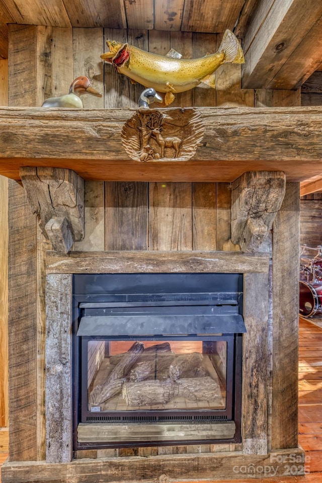 164 Avery County High School Rd, Newland, NC 28657 - detailed view of a glass covered fireplace, wood finished floors, and wood ceiling