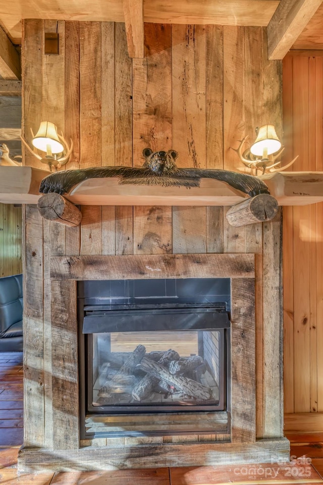 164 Avery County High School Rd, Newland, NC 28657 - detailed view of a glass covered fireplace, wooden walls, and wood finished floors