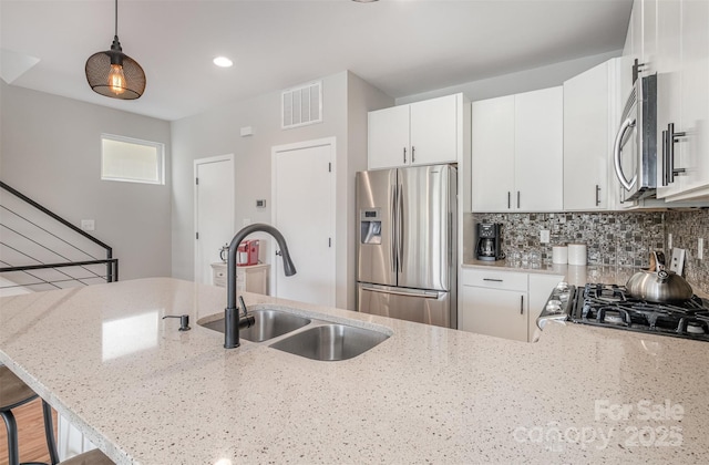 925 Westbrook Dr Unit B, Charlotte, NC 28202 - kitchen with stainless steel appliances, a sink, light stone countertops, pendant lighting, and recessed lighting