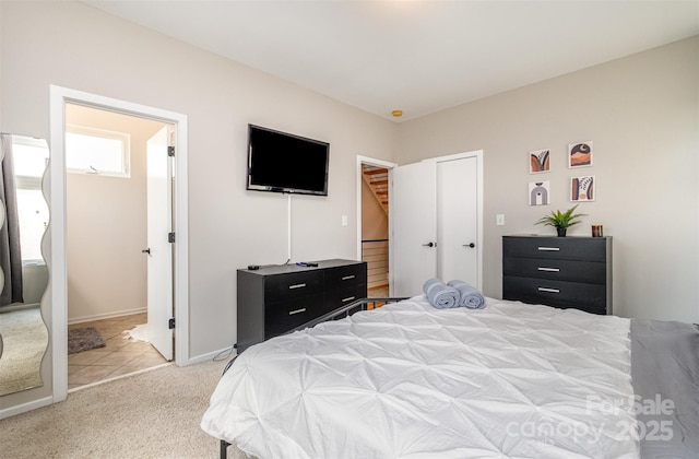 925 Westbrook Dr Unit B, Charlotte, NC 28202 - bedroom featuring light colored carpet, connected bathroom, and baseboards