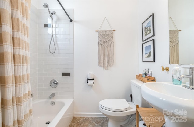 925 Westbrook Dr Unit B, Charlotte, NC 28202 - bathroom featuring toilet, shower / bath combo, a sink, and baseboards