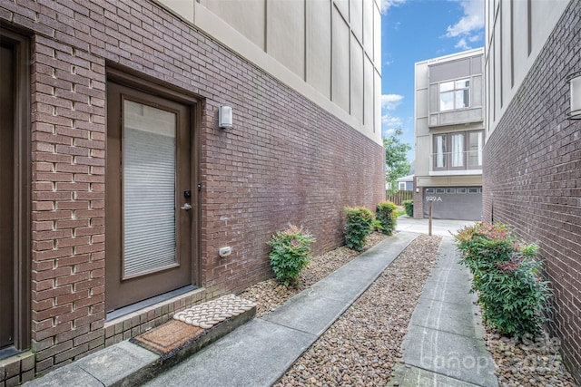 925 Westbrook Dr Unit B, Charlotte, NC 28202 - view of exterior entry featuring brick siding and an attached garage