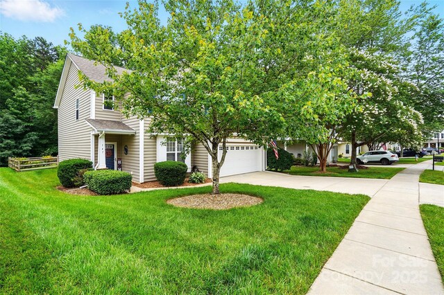 147 Whitley Mills Rd, Fort Mill, SC 29708 - obstructed view of property featuring driveway, a front yard, an attached garage, and roof with shingles