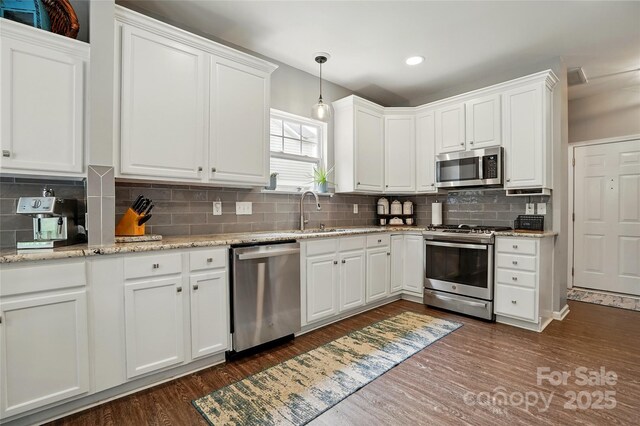 147 Whitley Mills Rd, Fort Mill, SC 29708 - kitchen featuring stainless steel appliances, a sink, dark wood finished floors, white cabinets, and backsplash