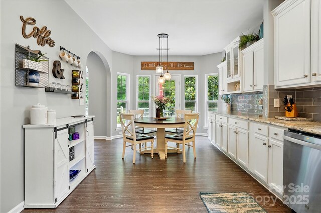 147 Whitley Mills Rd, Fort Mill, SC 29708 - dining area with dark wood-style flooring, arched walkways, and baseboards