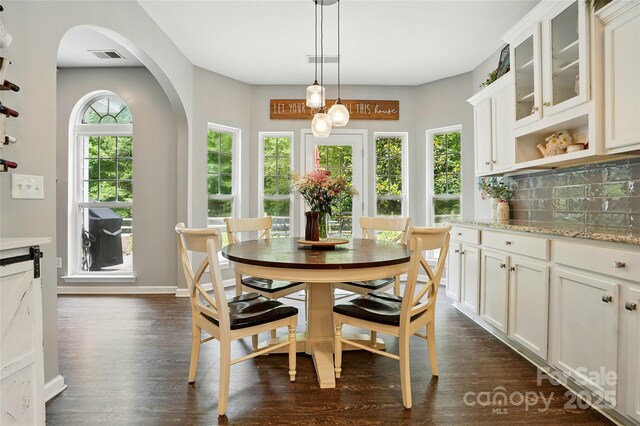 147 Whitley Mills Rd, Fort Mill, SC 29708 - dining space with arched walkways, dark wood-style flooring, and baseboards