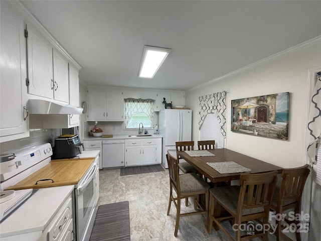 311 Tiffany St NW, Concord, NC 28027 - kitchen featuring white appliances, under cabinet range hood, a sink, light countertops, and ornamental molding