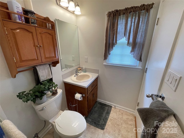 311 Tiffany St NW, Concord, NC 28027 - bathroom with vanity, toilet, and baseboards