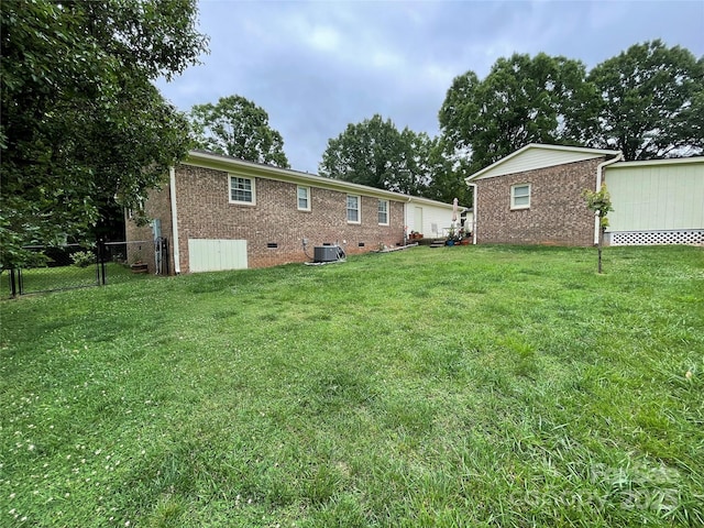 311 Tiffany St NW, Concord, NC 28027 - rear view of property featuring brick siding, crawl space, and central AC