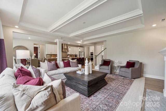 18129 Sulton Ter, Huntersville, NC 28078 - living room with crown molding, recessed lighting, stairs, light wood-style flooring, and ornate columns