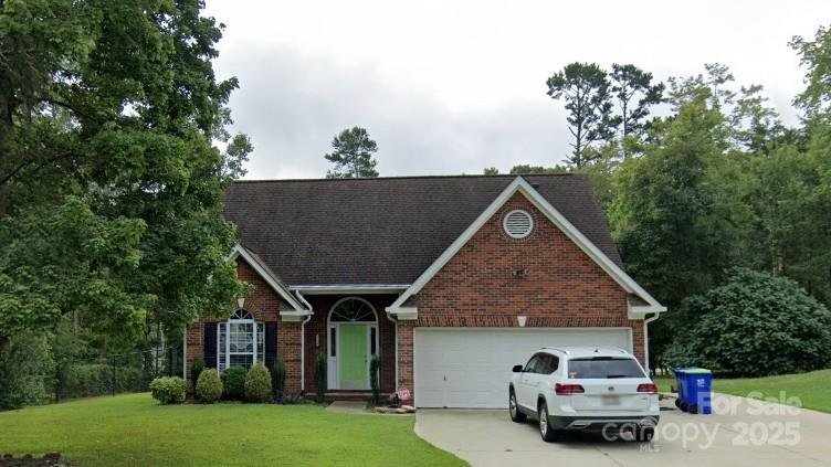 7134 Hunters Bluff Dr, Denver, NC 28037 - view of front of property with brick siding, a front yard, driveway, and a garage