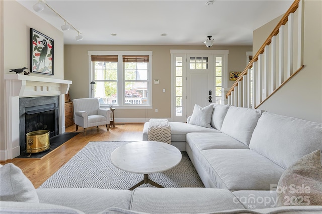 4 Fitzgerald Rd, Black Mountain, NC 28711 - living room featuring light wood-type flooring, stairs, baseboards, track lighting, and a high end fireplace