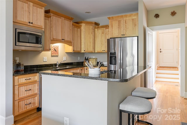 4 Fitzgerald Rd, Black Mountain, NC 28711 - kitchen with stainless steel appliances, a sink, light wood-style floors, and light brown cabinetry