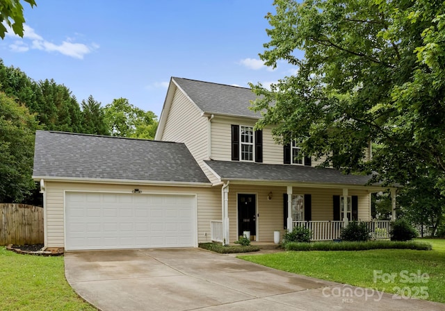 8808 Palmutum Pl, Charlotte, NC 28269 - traditional home with covered porch, concrete driveway, a garage, and a shingled roof