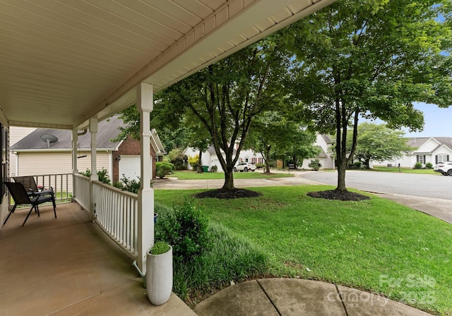 8808 Palmutum Pl, Charlotte, NC 28269 - view of grassy yard with covered porch and a residential view