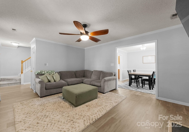 8808 Palmutum Pl, Charlotte, NC 28269 - living area with wood finished floors, stairway, ornamental molding, a ceiling fan, and a textured ceiling