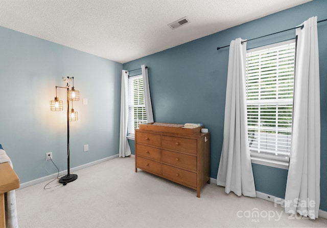 8808 Palmutum Pl, Charlotte, NC 28269 - carpeted bedroom featuring baseboards and a textured ceiling