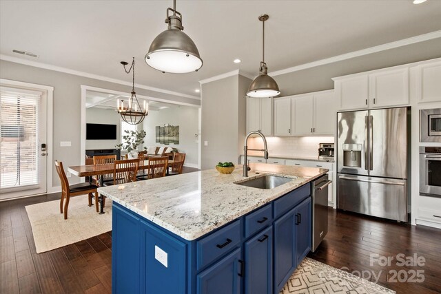 1244 Weir Ct, Fort Mill, SC 29708 - kitchen with stainless steel appliances, a sink, blue cabinets, dark wood finished floors, and recessed lighting