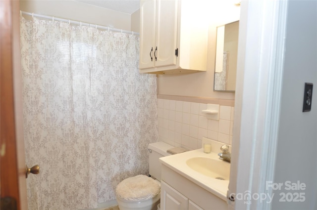 3505 Valley Dr, Chester, SC 29706 - bathroom featuring tile walls, toilet, vanity, and wainscoting