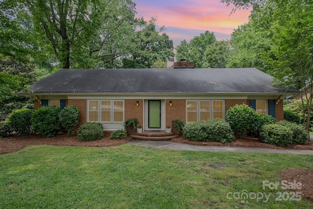 5926 Sharon Rd, Charlotte, NC 28210 - ranch-style house featuring brick siding, a lawn, a chimney, and roof with shingles