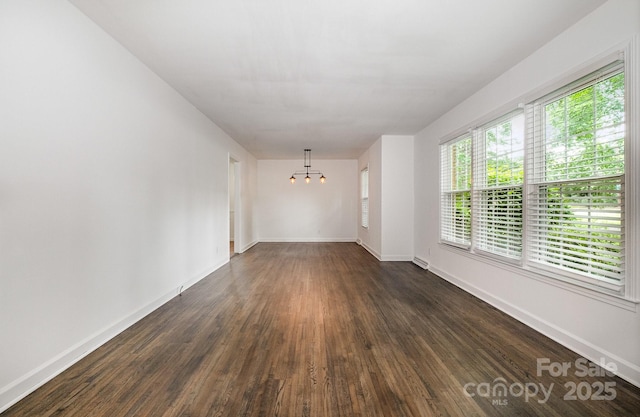 5926 Sharon Rd, Charlotte, NC 28210 - empty room with a chandelier, dark wood finished floors, and baseboards