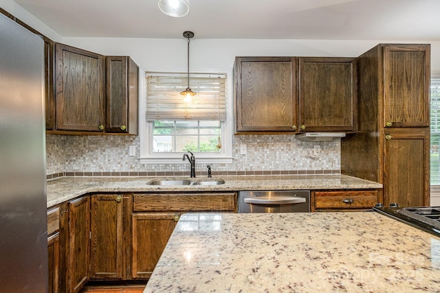 5926 Sharon Rd, Charlotte, NC 28210 - kitchen with appliances with stainless steel finishes, a sink, decorative backsplash, light stone counters, and decorative light fixtures