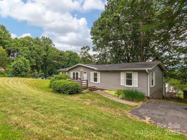 32 Lake Eden Cir, Black Mountain, NC 28711 - ranch-style home featuring a deck, a front yard, and a chimney