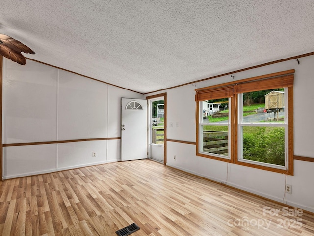 32 Lake Eden Cir, Black Mountain, NC 28711 - unfurnished room with a textured ceiling, ornamental molding, wood finished floors, lofted ceiling, and ceiling fan