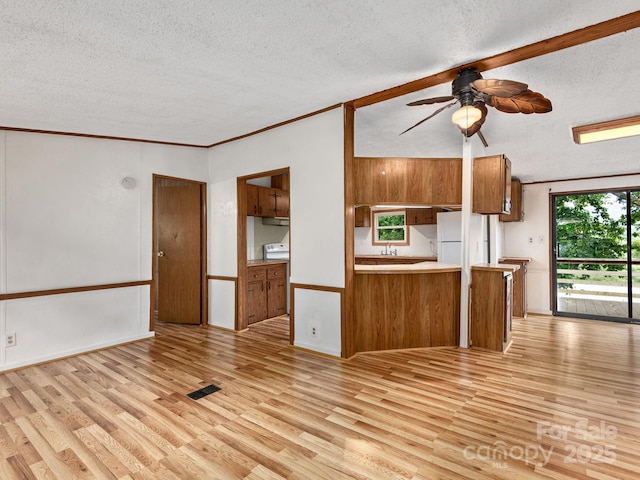 32 Lake Eden Cir, Black Mountain, NC 28711 - kitchen with brown cabinetry, a textured ceiling, freestanding refrigerator, light wood-style floors, and ceiling fan