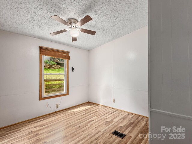 32 Lake Eden Cir, Black Mountain, NC 28711 - unfurnished room featuring a ceiling fan, a textured ceiling, and wood finished floors