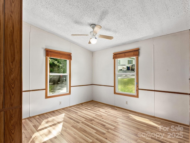 32 Lake Eden Cir, Black Mountain, NC 28711 - empty room featuring a textured ceiling, wood finished floors, a ceiling fan, and vaulted ceiling