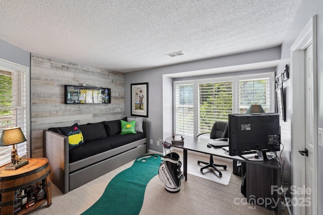 635 Portside Dr, Davidson, NC 28036 - home office featuring an accent wall, healthy amount of natural light, wooden walls, and a textured ceiling
