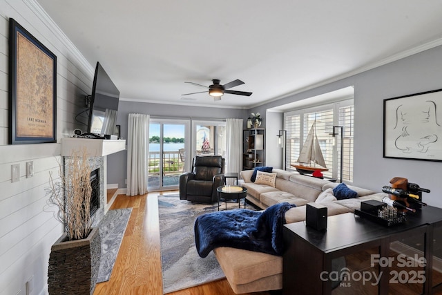 635 Portside Dr, Davidson, NC 28036 - living room with wood finished floors, crown molding, a fireplace, ceiling fan, and baseboards