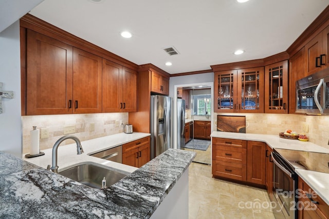 635 Portside Dr, Davidson, NC 28036 - kitchen with appliances with stainless steel finishes, a sink, light stone counters, backsplash, and recessed lighting