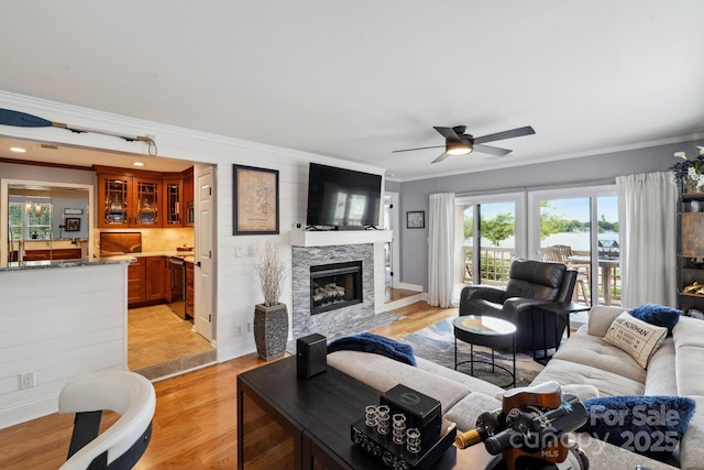 635 Portside Dr, Davidson, NC 28036 - living area featuring a ceiling fan, ornamental molding, a high end fireplace, and light wood-style floors