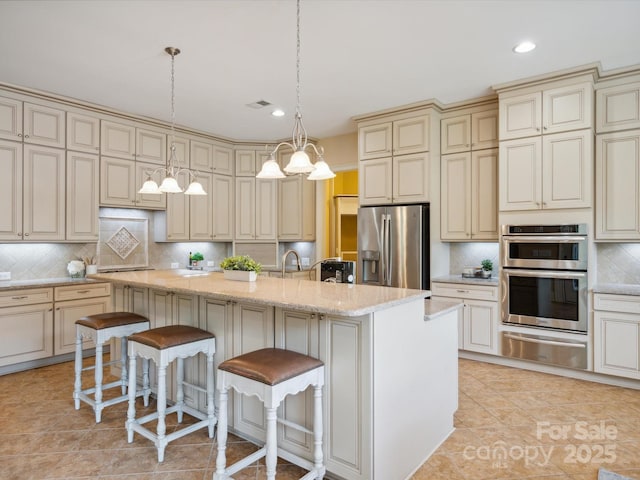 5805 Copperleaf Commons Ct, Charlotte, NC 28277 - kitchen with cream cabinetry, appliances with stainless steel finishes, a warming drawer, decorative backsplash, and recessed lighting