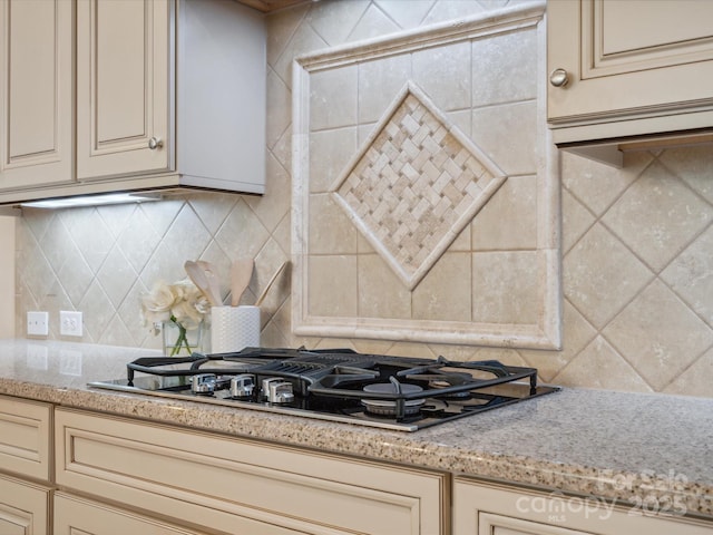 5805 Copperleaf Commons Ct, Charlotte, NC 28277 - kitchen with cream cabinetry, black gas stovetop, and tasteful backsplash