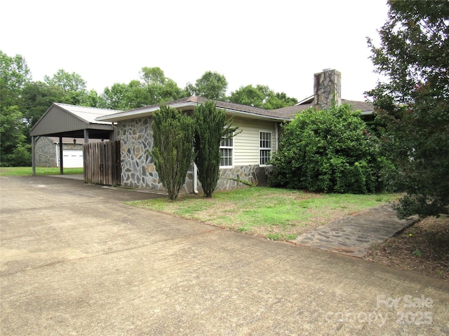 3838 Cliffside Rd, Mooresboro, NC 28114 - view of front of property featuring stone siding, a chimney, a front lawn, and driveway