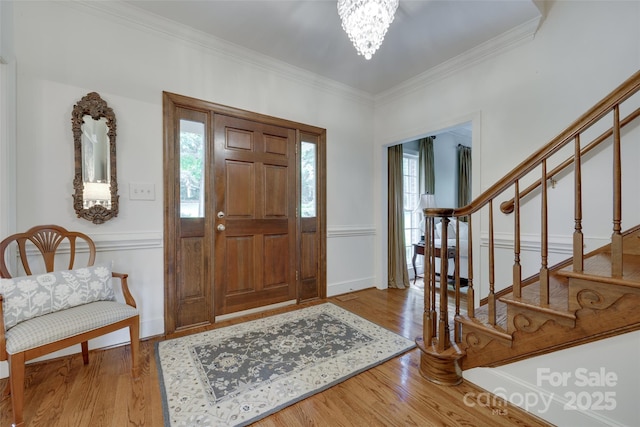 10215 Balmoral Cir, Charlotte, NC 28210 - foyer entrance featuring a chandelier, ornamental molding, stairway, and wood finished floors