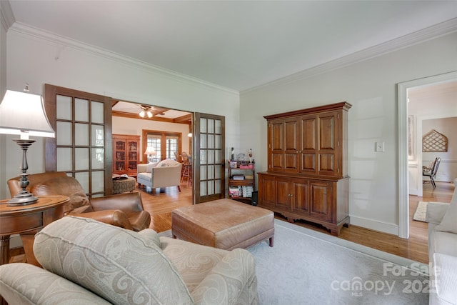 10215 Balmoral Cir, Charlotte, NC 28210 - living area featuring french doors, light wood-type flooring, crown molding, and a ceiling fan