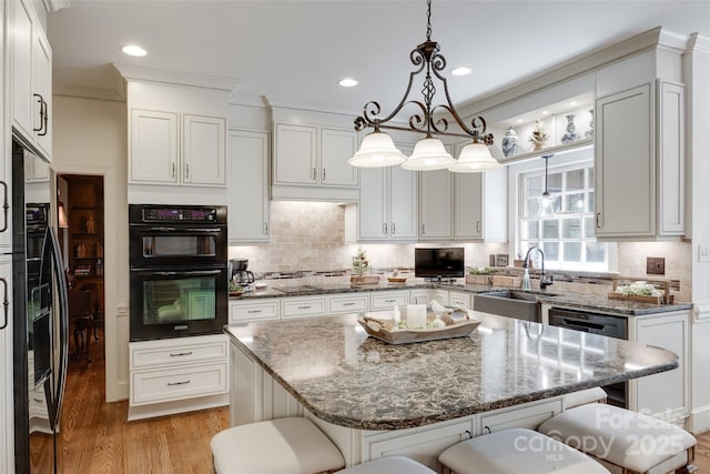 10215 Balmoral Cir, Charlotte, NC 28210 - kitchen featuring black appliances, a kitchen breakfast bar, white cabinetry, and recessed lighting