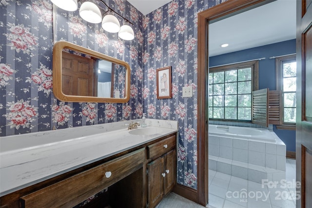 10215 Balmoral Cir, Charlotte, NC 28210 - full bath featuring vanity, tile patterned floors, a relaxing tiled tub, and wallpapered walls